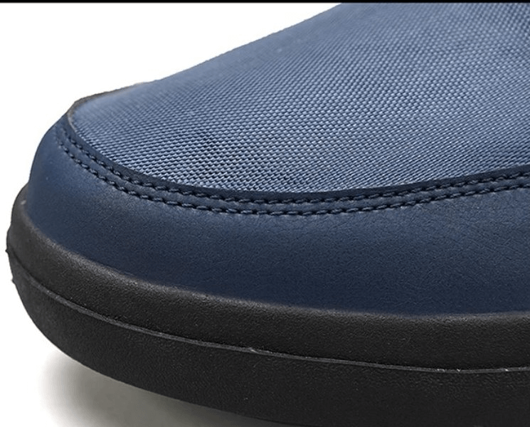 Close-up of blue non-slip waterproof hiking boot toe with rubber sole